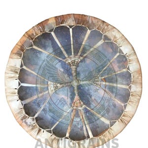 May include: Round, handcrafted drum with a natural leather rim and a patterned, blue-toned center. The drum's surface features a geometric design and the text "ANTIGRAINS" at the bottom. The drum's construction appears to be traditional.