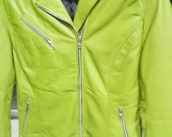 May include: A bright lime green leather jacket with a silver zipper closure and two zippered pockets. The jacket has a classic biker style with a notched collar and is hanging on a black hanger.