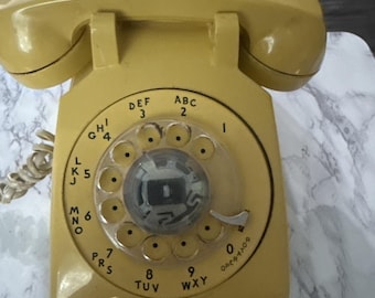 Teléfono de sobremesa giratorio antiguo Bell System Western Electric color amarillo oscuro/dorado