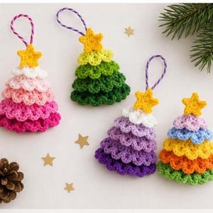 May include: Crocheted Christmas tree ornaments in various colors, including pink, green, purple, and yellow. Each tree has a yellow star on top and a loop for hanging. The ornaments are handmade and festive.