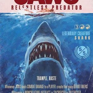 May include: A rectangular game card titled JAWS RELENTLESS PREDATOR featuring a large shark emerging from blue water toward a swimmer. The card displays text including LEGENDARY CREATURE SHARK, 5/5, TRAMPLE, HASTE, and game rules, with a BASH GAMING logo.