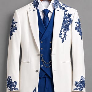 May include: A white long coat featuring blue floral embroidery on the lapels, sleeves, and hem, paired with a blue vest, blue trousers, a white collared shirt, and a blue necktie. A silver chain is attached to the front of the blue vest.