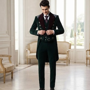 May include: A dark green velvet tailcoat suit featuring a deep burgundy velvet lapel, double-breasted button detailing, and silver embroidery on the shoulders. The ensemble includes a matching vest, trousers, a white dress shirt, and a dark tie.