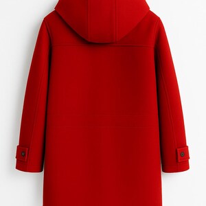 May include: A bright red hooded coat featuring a structured design with long sleeves, buttoned cuffs, and a smooth finish. The coat is displayed on a black hanger, showcasing a clean, solid-colored exterior with visible seam detailing across the back.