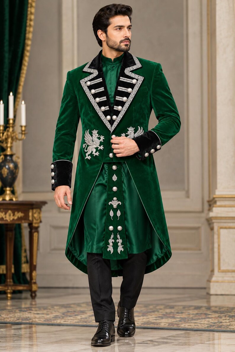 May include: A dark green velvet long coat featuring black velvet lapels and cuffs, silver embroidery of griffins, and silver buttons. The coat is worn over a matching green tunic with a central vertical panel of silver buttons and embroidery, paired with black trousers.