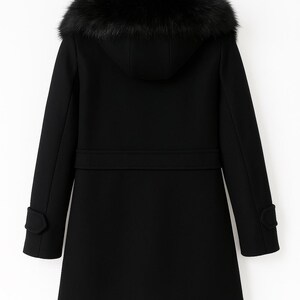 May include: A black winter coat with a hood trimmed with dark faux fur. The coat features a belt detail at the waist, and buttoned cuffs. The coat is designed for warmth and style.