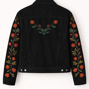 May include: A black denim jacket featuring long sleeves and a back panel decorated with embroidered floral patterns. The embroidery consists of orange flowers with green stems and leaves running down each sleeve and across the upper back.