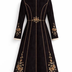 May include: A long black coat featuring a cream-coloured faux shearling collar and sleeve cuffs. The coat is decorated with gold-toned floral embroidery on the sleeves and lower panels, with vertical gold-toned piping along the seams.