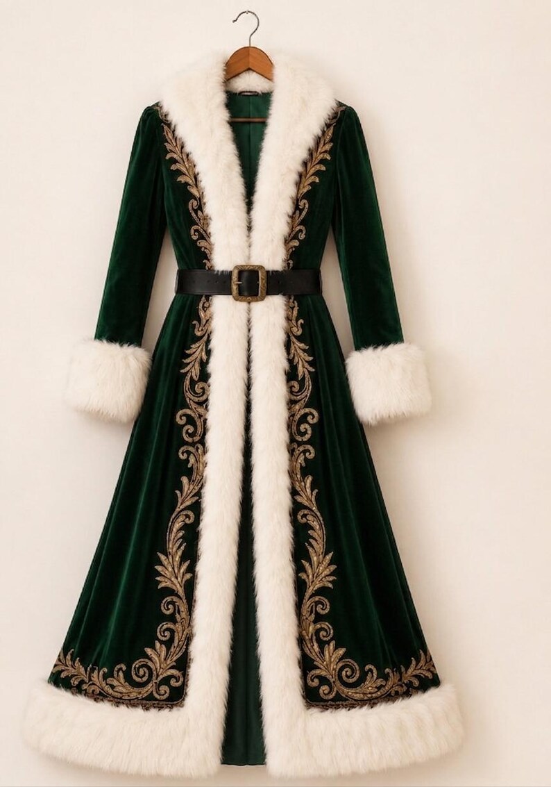 May include: A long, dark green velvet coat featuring a white faux fur collar and cuffs, adorned with intricate gold embroidery along the front panels. The coat is cinched at the waist with a black belt that has a rectangular gold-toned buckle.