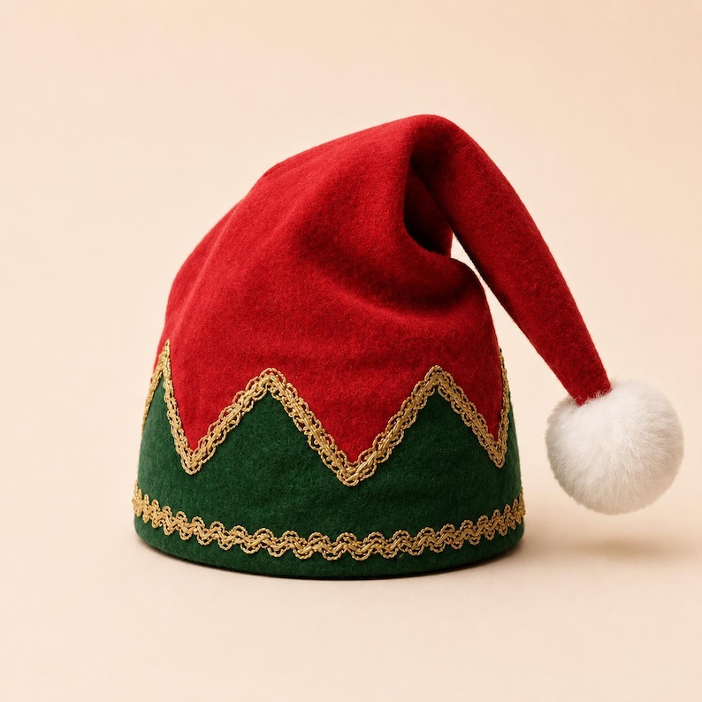 May include: A red and green felt hat featuring a zigzag pattern along the base. The hat is accented with gold metallic trim along the edges and a white pom-pom attached to the tip. The design is structured with a pointed, drooping top section.