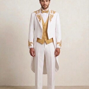 May include: A white tailcoat suit featuring gold embroidery on the lapels and cuffs, paired with a gold vest, a white pleated shirt, a gold bow tie, and white dress shoes. The ensemble includes matching white trousers with a clean, tailored finish.