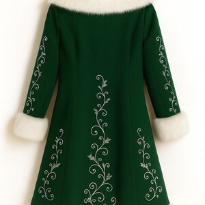 May include: A dark green coat featuring a white faux fur collar, white faux fur sleeve cuffs, and a white faux fur hem. The coat is decorated with silver-colored embroidered floral vine patterns running down the center and along the sleeves.