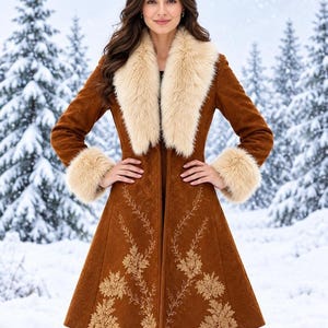 May include: A knee-length brown coat featuring a wide cream-colored faux fur collar and matching faux fur cuffs. The coat is decorated with intricate gold-toned floral embroidery extending from the hemline up the front panels.