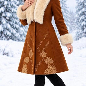 May include: A knee-length brown coat featuring a cream-colored faux fur collar and matching faux fur cuffs on the sleeves. The coat is decorated with intricate, light-colored floral embroidery patterns along the front panels and hemline.