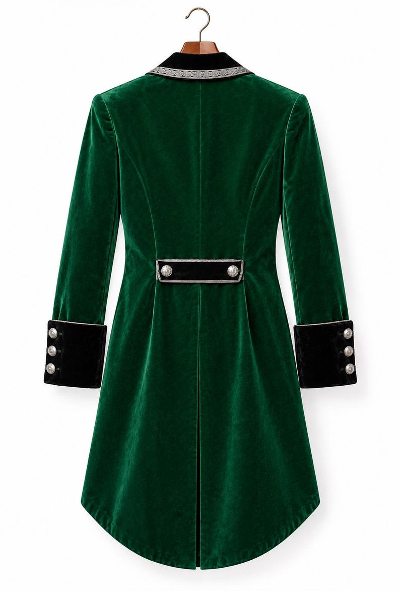May include: A long-sleeved emerald green velvet coat featuring a black velvet collar with silver trim, black velvet cuffs with three silver buttons each, and a horizontal black velvet back tab detail adorned with two silver buttons.
