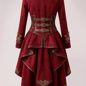 May include: A deep red long-sleeved coat featuring a high collar, brown leather-like trim, and three horizontal buckled straps at the waist. The coat has a tiered, high-low hemline and is decorated with metallic gold gear-shaped embellishments.