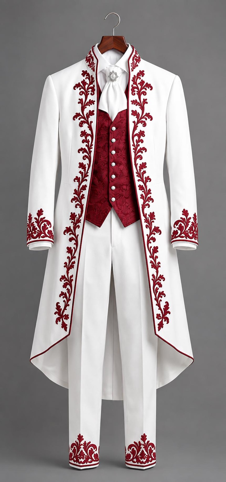 May include: A white tailcoat suit featuring deep red floral embroidery along the lapels, cuffs, and pant hems. The ensemble includes a matching white shirt, a white cravat with a decorative pin, and a deep red patterned vest with white buttons.