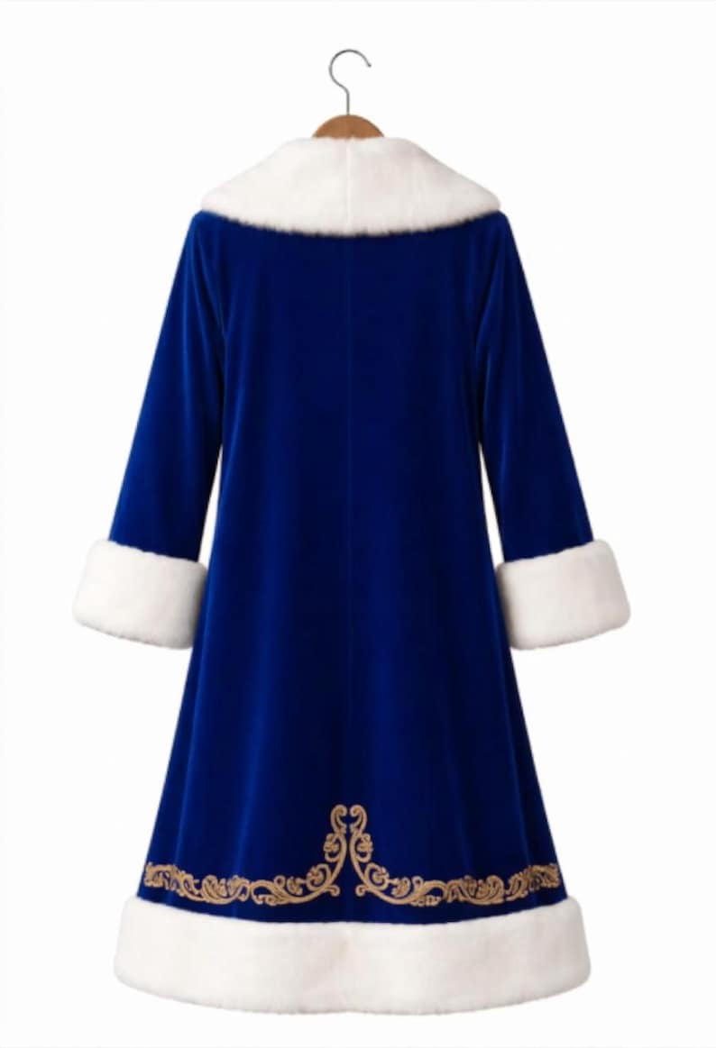 May include: A royal blue velvet coat featuring a white faux fur collar and matching white faux fur cuffs on the long sleeves. The hem is decorated with an intricate gold embroidered scrollwork pattern above a wide white faux fur border.
