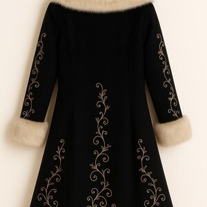 May include: A black coat featuring a beige faux fur collar, cuffs, and hem. The coat is decorated with gold-colored embroidered vine patterns running down the center back and along the outer length of each sleeve, hanging on a wooden hanger.