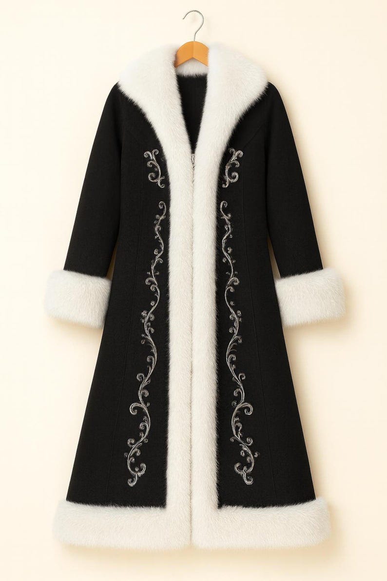 May include: A long black coat featuring a thick white faux fur collar, white faux fur cuffs, and white faux fur trim along the front opening. The coat is decorated with intricate silver embroidery in a scrolling vine pattern on both sides.