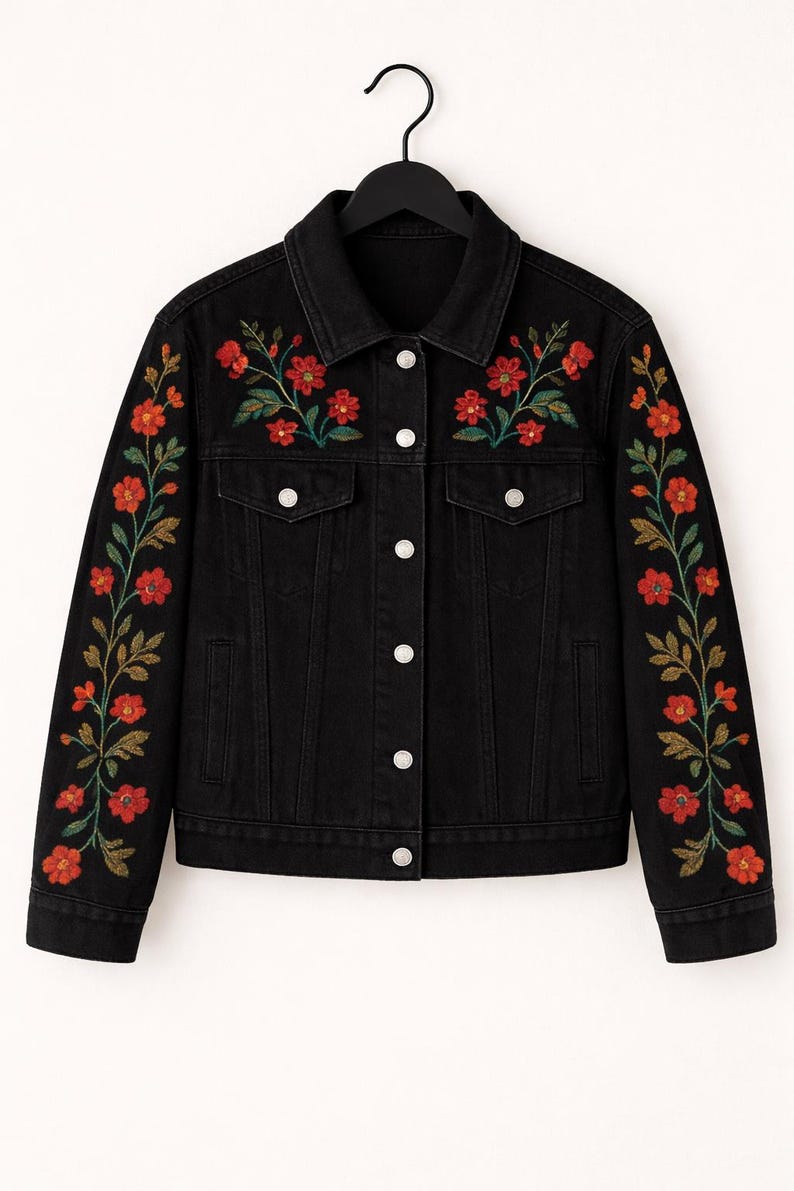 May include: A black denim jacket featuring a pointed collar, silver-toned metal buttons, and two chest pockets. The front shoulders and the full length of both sleeves are decorated with embroidered red flowers and green leafy vines.