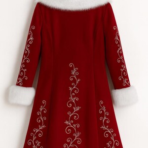 May include: A deep red long-sleeve coat featuring white faux fur trim on the collar, cuffs, and hem. The coat is decorated with intricate white swirling vine embroidery patterns running down the center and along the length of each sleeve.