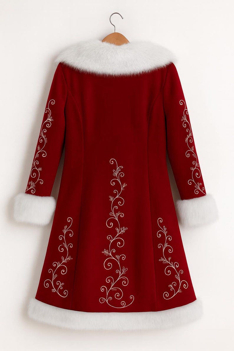 May include: A deep red long-sleeve coat featuring white faux fur trim on the collar, cuffs, and hem. The coat is decorated with intricate white swirling vine embroidery patterns running down the center and along the length of each sleeve.