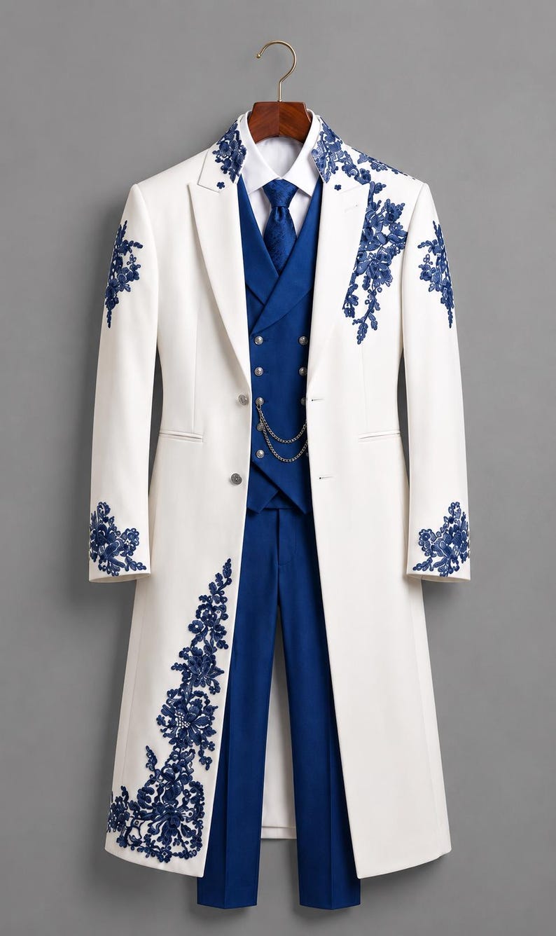 May include: A white long coat featuring blue floral embroidery on the lapels, sleeves, and hem, paired with a blue vest, blue trousers, a white collared shirt, and a blue necktie. A silver chain is attached to the front of the blue vest.