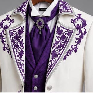 May include: A white blazer featuring purple floral embroidery on the lapels, worn over a purple vest with a subtle pattern and a white collared shirt. A purple cravat is secured with an ornate silver brooch featuring a central purple stone.
