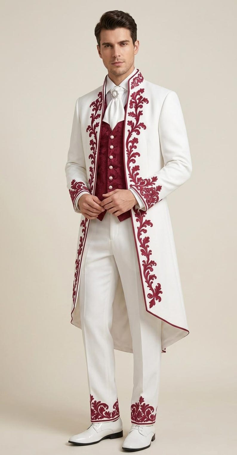 May include: A white long-coat suit featuring deep red floral embroidery along the lapels, cuffs, and pant hems. The ensemble includes a white collared shirt, a white cravat with a central pin, a deep red textured vest with white buttons, and white shoes.