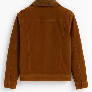 May include: A brown corduroy jacket with a contrasting faux shearling collar. The jacket features a classic design with a button closure, two chest pockets, and a straight hem. The jacket is hanging on a black hanger.