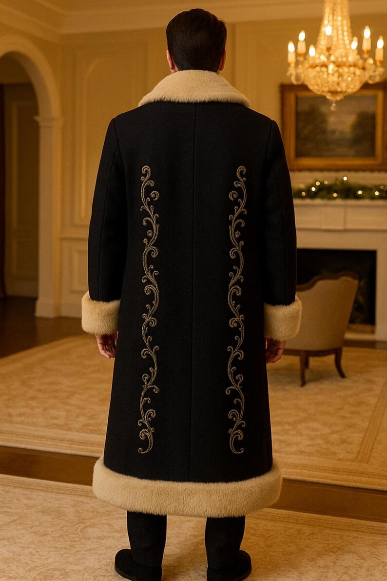May include: A long black coat featuring a beige faux fur collar, cuffs, and hem. The back of the coat is decorated with two vertical rows of intricate gold embroidery in a swirling scroll pattern that runs from the shoulders to the lower hem.