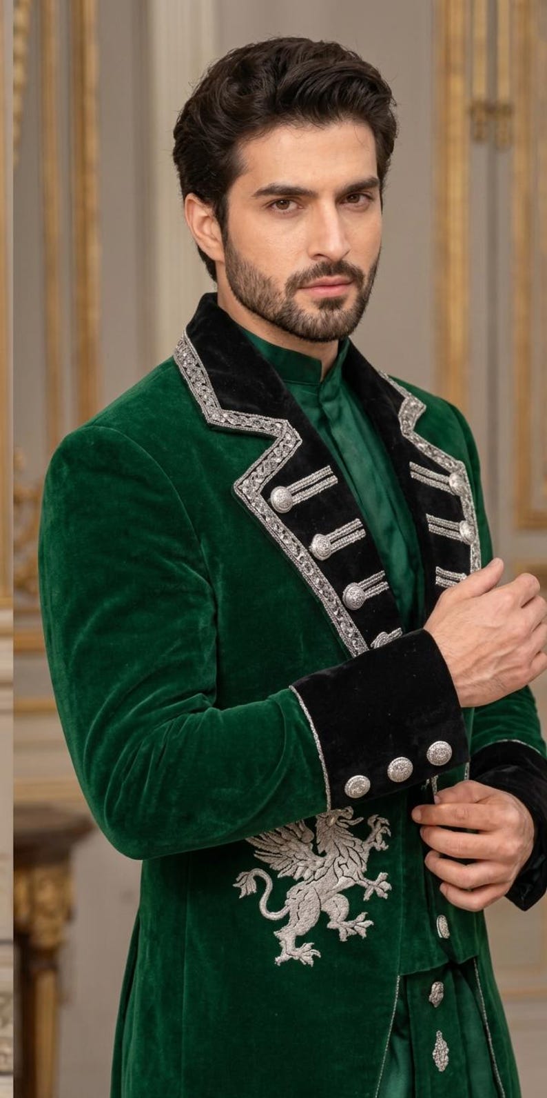 May include: A deep green velvet jacket featuring a black velvet lapel with silver metallic embroidery and silver buttons. The jacket includes a prominent silver embroidered griffin emblem on the lower front panel and matching black velvet cuffs.