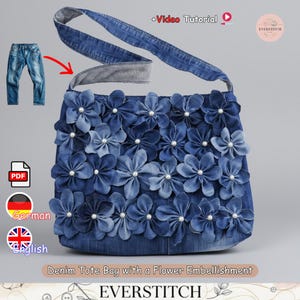 May include: A denim tote bag with a flower embellishment. The bag is adorned with numerous blue denim flowers, each centered with a pearl. The bag has a denim strap and is displayed with a pair of jeans.