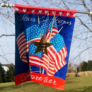 Large Stars and Stripes Forever Flag 28”x40”. Rank, Name and Dates placed on two Gold Stars, one on each side.