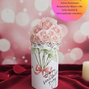 May include: A Valentine's Day gift featuring a cylindrical container with a bouquet of pink roses. The container is decorated with a watercolor illustration of roses and the text "Happy Valentine's Day".