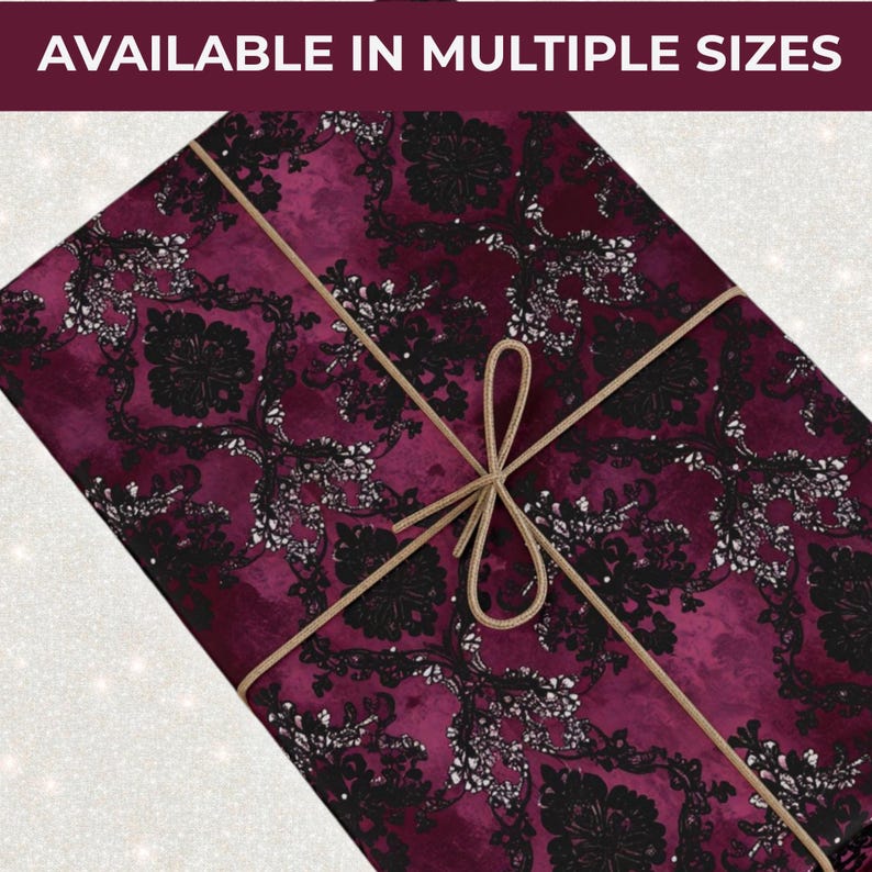 May include: A gift wrapped in burgundy paper with a black and white floral pattern, tied with a gold string. The text "AVAILABLE IN MULTIPLE SIZES" is at the top.