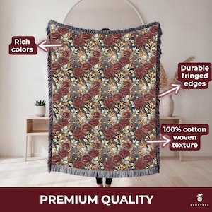 May include: Woven cotton throw blanket with a floral rose pattern in burgundy, gold, and green on a dark background. The blanket has fringed edges and the text "PREMIUM QUALITY".