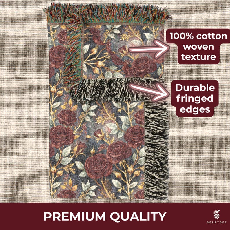 May include: A woven cotton throw blanket with a floral pattern of burgundy roses and gold leaves on a dark blue background. The blanket has durable fringed edges and the text "Premium Quality".