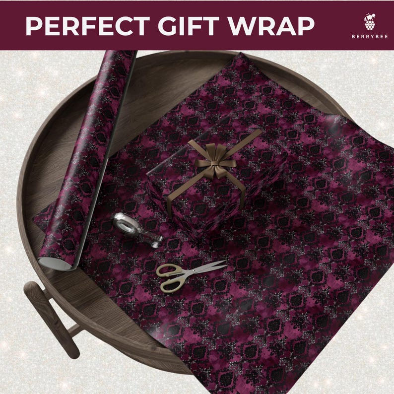 May include: A roll of patterned wrapping paper, a wrapped gift, and wrapping supplies are arranged on a wooden tray. The wrapping paper and gift box feature a dark magenta and black design. The text "PERFECT GIFT WRAP" is at the top.