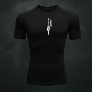 May include: Black short-sleeve compression shirt with a white graphic of a sword and Japanese text. The shirt is form-fitting and has a crew neck.