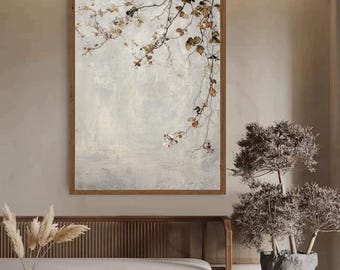 May include: A framed artwork featuring a muted, textured background with a branch of delicate flowers and leaves. The artwork is encased in a brown wooden frame. The color palette includes soft whites, browns, and touches of pink.