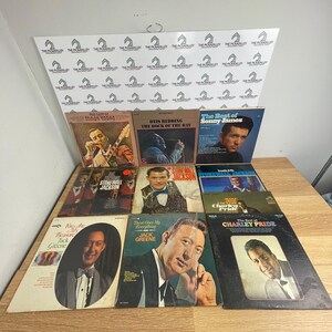 May include: A collection of nine vintage vinyl record albums featuring artists such as Faron Young, Otis Redding, Sonny James, Stonewall Jackson, Charley Pride, and Jack Greene, displayed in three rows with various cover art and text titles.