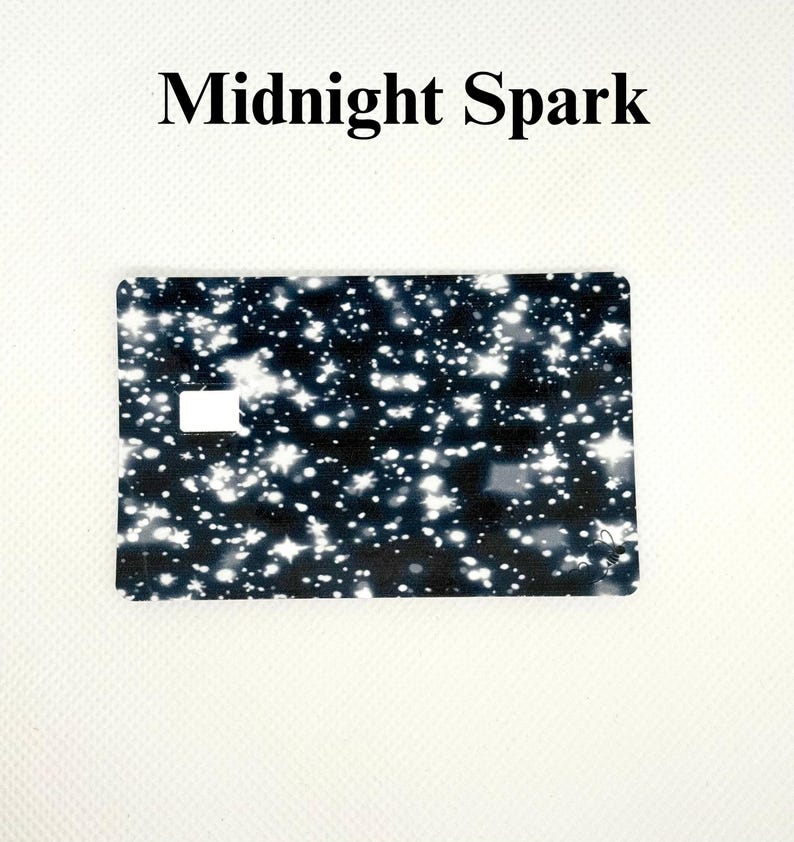 Pu&ograve; includere: Una carta rettangolare con sfondo nero punteggiato da disegni bianchi a forma di stella e rotondi. Il testo "Midnight Spark" &egrave; stampato in nero nella parte superiore della carta.