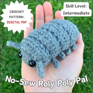 May include: A handmade grey crocheted woodlouse, held in a hand, with black eyes and antennae. The image includes text that reads "CROCHET PATTERN: DIGITAL PDF", "Skill Level: Intermediate", and "No-Sew Roly Poly Pal".