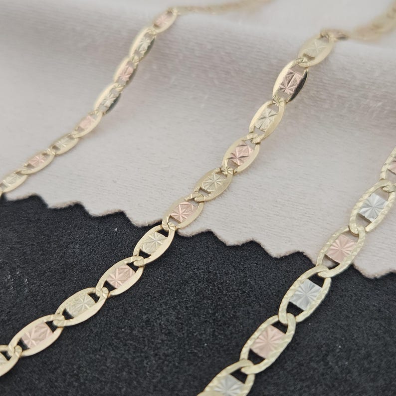 10K solid gold tri-color Valentino bracelet featuring yellow, rose, and white gold diamond-cut textured links with a lobster clasp.