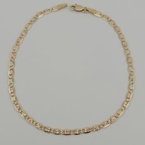 May include: A gold chain bracelet featuring a series of oval-shaped links with a textured, multi-tone finish. The bracelet is constructed from alternating yellow and rose gold segments, connected by a secure lobster claw clasp at the top.