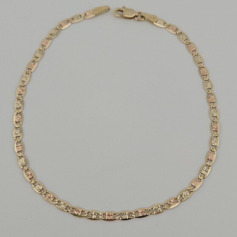 May include: A gold chain bracelet featuring a series of oval-shaped links with a textured, multi-tone finish. The bracelet is constructed from alternating yellow and rose gold segments, connected by a secure lobster claw clasp at the top.