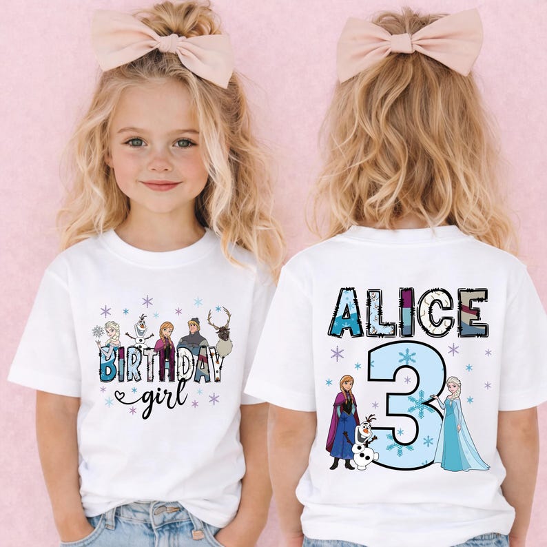 May include: White t-shirts with a colorful graphic featuring characters and text from a popular animated movie. The front of the shirt says "BIRTHDAY girl" and the back says "ALICE 3". The shirts are worn by a young child.
