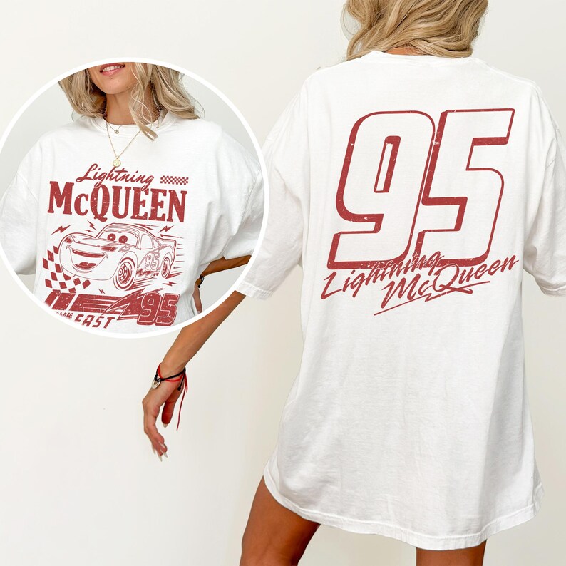 May include: White t-shirt featuring a red graphic of Lightning McQueen and the number 95. The front design includes the text "Lightning McQueen" and a race car illustration. The back of the shirt displays a large "95" and "Lightning McQueen".